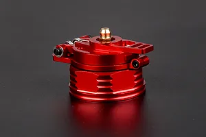 A red anodized aluminium fuel tank cap for RC vehicles, featuring a hinged design and a brass-coloured central fitting.