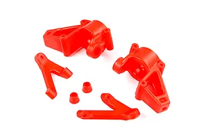A set of bright red nylon RC car front steering hubs and suspension components on a white background.