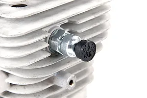 Close-up of a pressure reducing valve installed on a finned metal RC engine cylinder head.