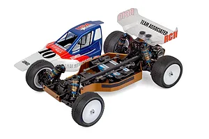 Team Associated 1/10 scale 4WD electric RC buggy chassis with bronze aluminum chassis plate, white wheels, and a separate painted body shell.