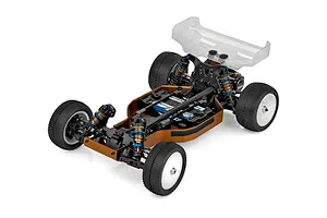 High angle studio shot of Team Associated RC10 4WD electric buggy chassis kit featuring carbon fiber shock towers and bronze chassis.