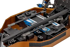 Close-up studio view of the chassis layout and electronics compartment of the Team Associated RC10 4WD RC buggy kit.