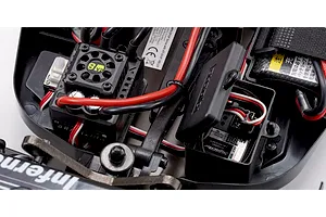 Close-up studio view of the electronic speed controller and receiver box inside the Kyosho Inferno MP10e 1/8 scale RC buggy.