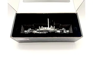 Reefs RC aluminium front portal axle set in silver, nestled inside its protective black foam packaging box.