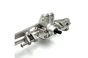 Silver aluminium RC rear axle housing with integrated link mounts and drive shaft input against a white background.
