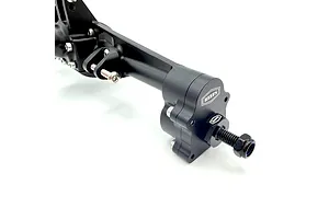 Close-up of the black aluminium rear portal axle set showing the portal housing, hex adapter, and branding.