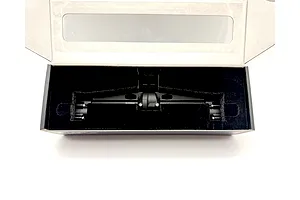 A black metal RC portal axle housed securely inside a custom cutout foam packaging box.