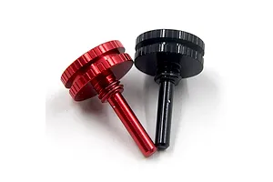 Two aluminium adjustable bullet plug grips in red and black against a plain white background.