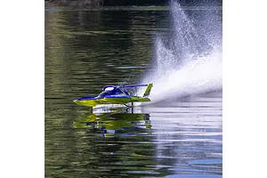 Pro Boat Miss Illinois U-34 RC boat speeding across calm water, creating a large rooster tail splash.