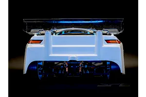 Rear view of the RC Maker SP2 EP RC Touring Car showing suspension details, white body, and clear wing.