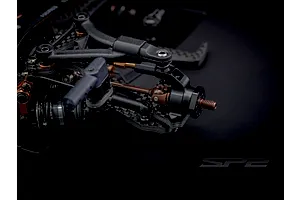 Close-up studio view of the front suspension and steering assembly of the RC Maker SP2 EP RC Touring Car.