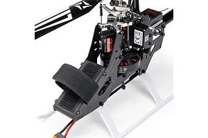 Close-up studio view of the Blade InFusion 210 RC helicopter frame, showing carbon fiber chassis, servos, motor, and rotor head details.