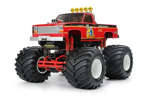 Studio product photo of the Tamiya Clod Buster 1/10 scale red electric 4WD RC monster truck on a white background.