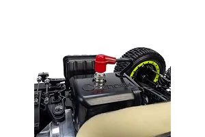 Close-up view of the petrol engine and spark plug with red boot inside the Losi 35.2cc 5IVE-TG 3.0 RC short course truck.