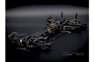 Studio product view of the RC Maker SP2 EP RC touring car chassis featuring carbon fibre and metal components.