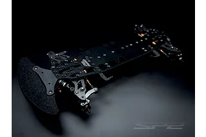 RC Maker SP2 EP RC Touring Car chassis kit viewed from a high angle against a dark studio background.