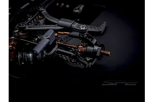 Close-up of the front suspension and steel drive shaft on the RC Maker SP2 1/10 electric touring car kit.