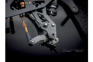 Close-up view of the carbon fibre suspension and steering assembly on the RC Maker SP2 RC touring car.