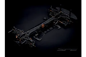 RC Maker SP2 EP RC Touring Car chassis kit viewed from above on a black background