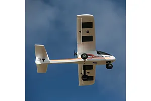 HobbyZone AeroScout RC airplane flying overhead against a clear blue sky background.
