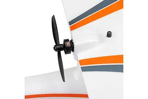 Close-up of the electric motor, black propeller, and white foam wing with orange and grey stripes on the HobbyZone AeroScout S 2 RC plane.