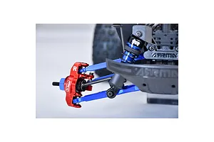 Close-up of a red anodized aluminium steering hub installed on an RC car suspension assembly with blue parts.