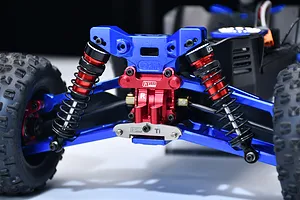 GPM titanium rear suspension pin brace installed on an RC car rear assembly with blue and red anodized aluminum parts.