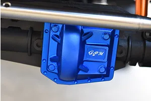 Blue anodized aluminum GPM gearbox cover installed on an RC vehicle axle, featuring hex hardware and logo branding.