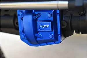 Close-up of a blue anodized aluminium GPM differential cover installed on an RC vehicle axle housing.