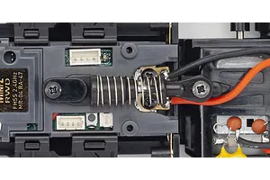 Close-up top view of the MR-04 chassis layout showing electronic components, spring damper, and wiring.