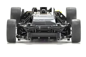 Front view of an RC car chassis showing the front suspension, steering links, and rubber tires against a white background.