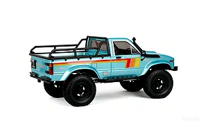 Light blue RGT Pioneer V2 Pro RC rock crawler truck viewed from rear-three-quarter angle against a white background.