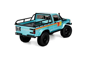 Rear three-quarter studio view of the light blue RGT Pioneer V2 Pro 1/10 scale RC rock crawler truck.