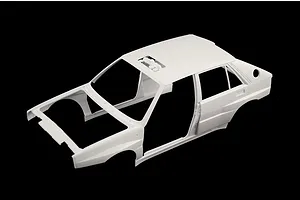 Unpainted white plastic model car body shell for the Italeri Lancia Delta Integrale against a black background.