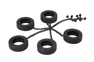 Five black model car rubber tires and small parts on a sprue against a plain white background.