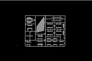 Grey plastic model kit sprue containing aircraft parts such as wings, weapons, and ordnance on a black background.