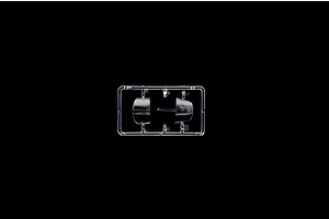 Clear plastic sprue containing transparent model aircraft canopy parts against a black background.