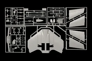 Grey plastic model kit sprue frames containing aircraft parts against a black background.