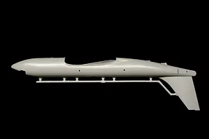 Unpainted light grey plastic model kit fuselage part attached to a sprue against a black background.