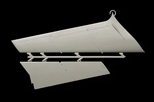 Grey plastic model kit parts sprue showing aircraft wing and tail sections on a plain black background.
