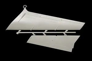Grey molded plastic model kit parts sprue showing aircraft vertical stabilizer and rudder components against a black background.