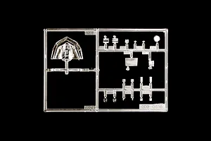 Clear plastic model parts sprue featuring cockpit canopy and small transparent pieces on a black background.
