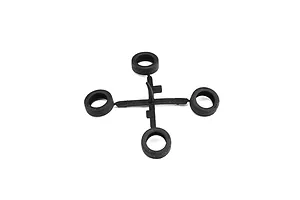 A sprue of four black rubber or plastic model car tires on a clean white background.