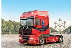 A completed and painted 1/24 scale Italeri DAF XF 95 Super Space Cab semi truck model featuring Lady Cat graphics parked on a cobblestone plaza.
