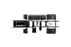 Top-down studio view of a black plastic semi truck scale model chassis assembly against a white background.