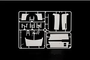 White plastic model kit sprue featuring various body panels and parts against a black background.