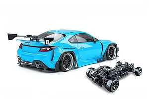MST light blue GR86 RC drift car body with widebody kit and rear wing, shown alongside its chassis on a white background.