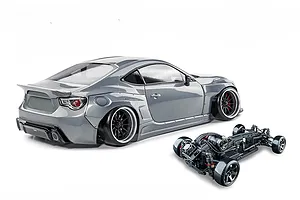 MST 86RB RC drift car in metal grey with widebody kit shown alongside its assembled chassis on a white background.