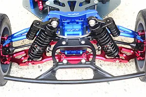 Front end of an RC car installed with blue, red, and black aluminum and steel upgrade parts.