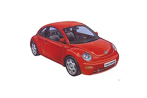 A studio shot of a red Tamiya 1/24 scale Volkswagen New Beetle plastic model car, shown from a high-angle front three-quarter view.